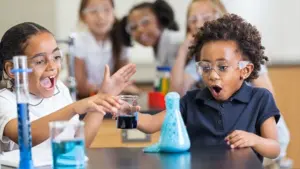 Mad-Science-Week a child concentrating on a practical life activity, using real-world tools
